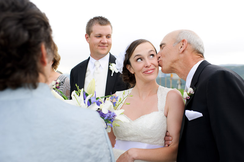 Father of the bride kissing bride 