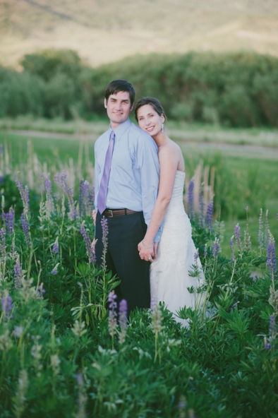 Bride and groom in field of lupine; Colorado wedding 