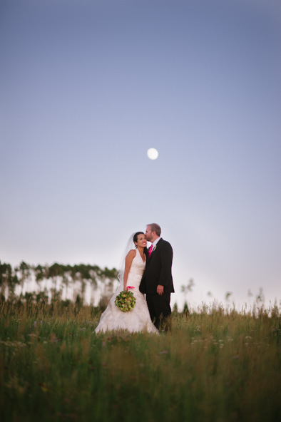 bride and groom under full moon
