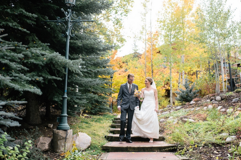 Bride and groom walking through Vail