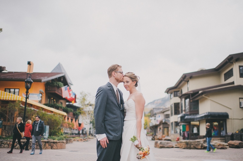 bride and groom with colorful signs in Vail